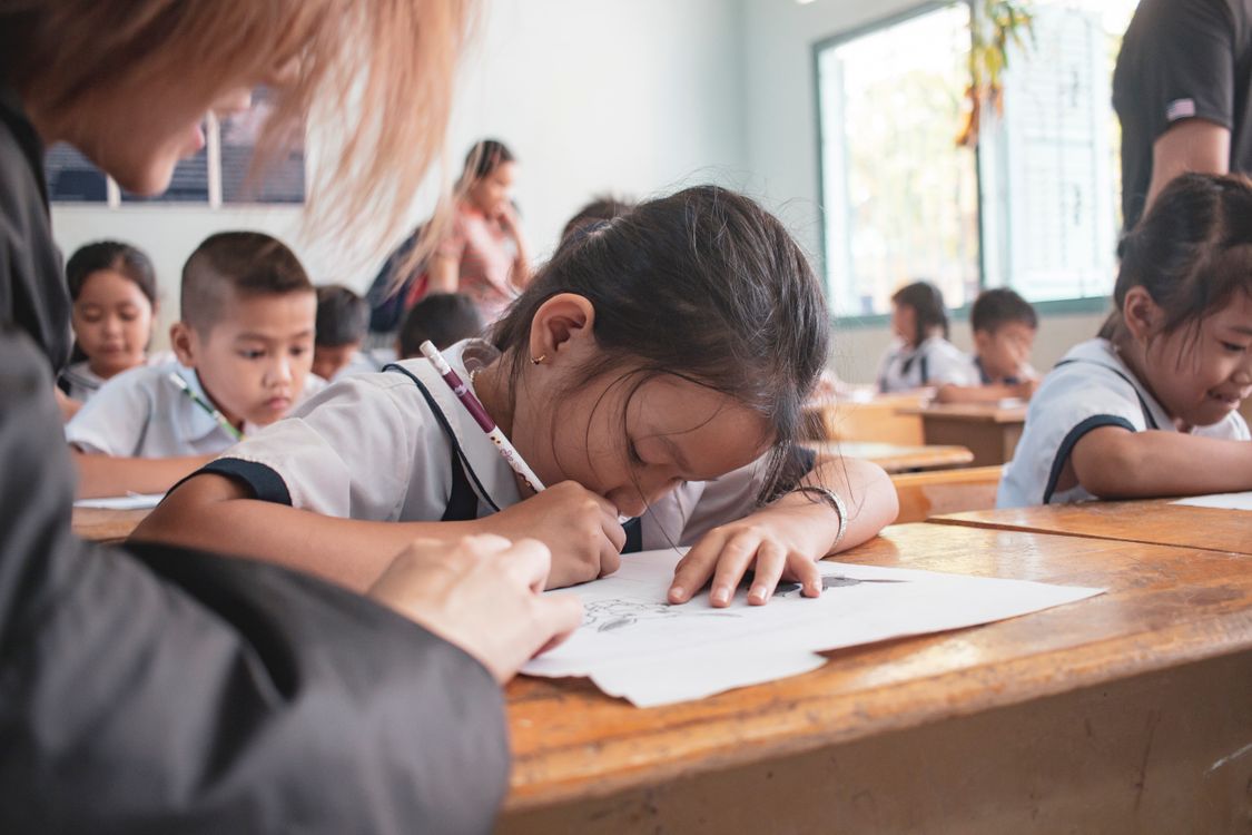 Pupils concentrating on writing activities at their desks